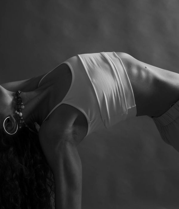 Woman in a graceful yoga pose focusing on balance and inner peace.